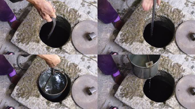 农村水桶在水井里打水特写素材