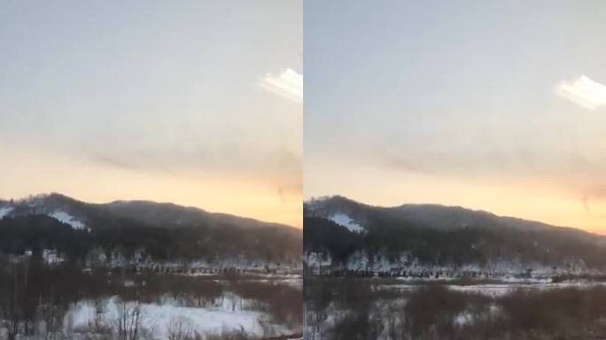 冬日黄昏下的雪覆铁路与远山