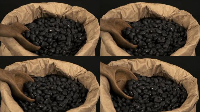 宏观特写:干黑龟豆在纸袋中旋转