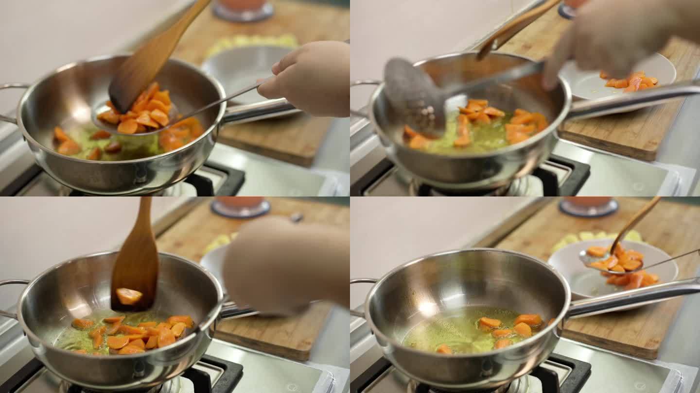 女人用煎锅煎胡萝卜