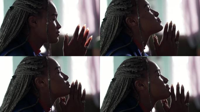 一位有灵性的年轻黑人妇女怀着希望和信心向上帝祈祷。闭着眼睛沉思的巴西人
