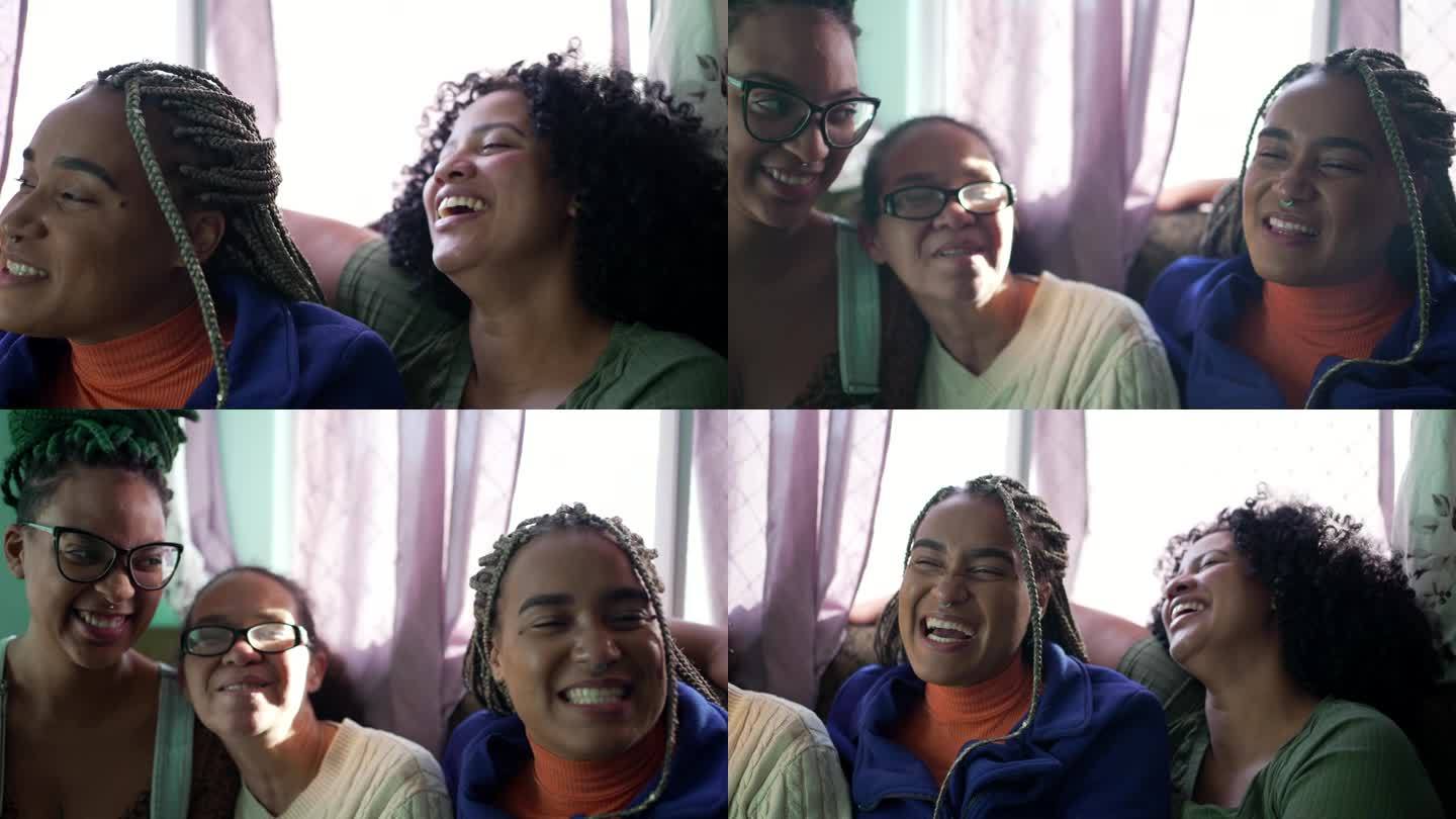 快乐的巴西女人坐在沙发上一起笑。快乐的南美人民。真实生活中的笑和微笑