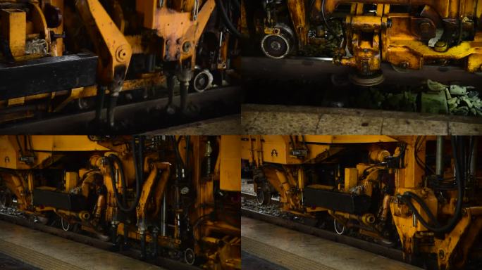铁路机车机械维护修理轨道铁路线路。在火车站用黄色金属钢动力车在铁路上运输重工业。机械、机械、轨道、工