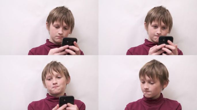 悲伤的少年用手机和女友聊天。单恋，尴尬的年龄。青少年在家里用智能手机打短信。2月14日情人节浪漫。在