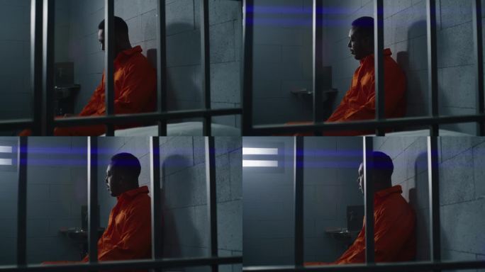 非裔美国囚犯坐在监狱床上