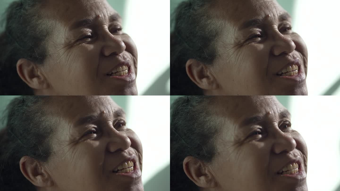 快乐的特写脸一个西班牙裔老年妇女微笑的天空与希望和信念。南美巴西老年女性