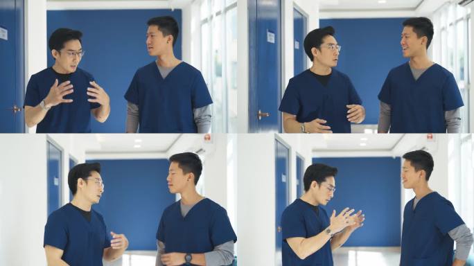 两名中国男护士在喝咖啡休息时走在走廊上聊天