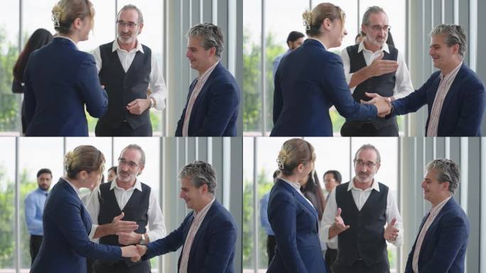 在公司的研讨会上，白人男领导向女经理介绍新的团队伙伴。男领导介绍女经理，与女经理握手欢迎新员工