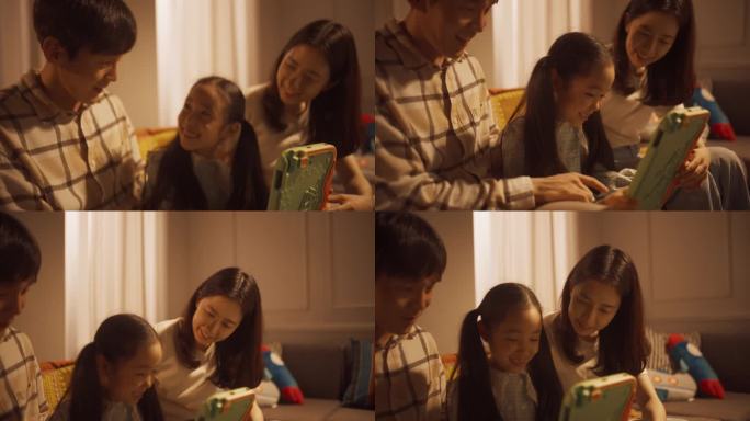 一个韩国小女孩在父母的帮助下在家用平板电脑做作业的照片。年轻夫妇支持孩子的教育并与她共度美好时光