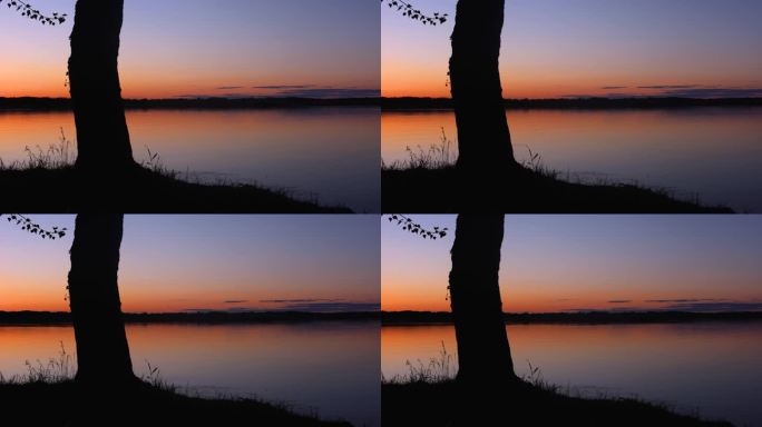 水泵旁美丽的夕阳和岸边的树随着时间流逝，渐渐暗下来。黄昏，晴朗的天空，水面，太阳落在河上。傍晚江景如