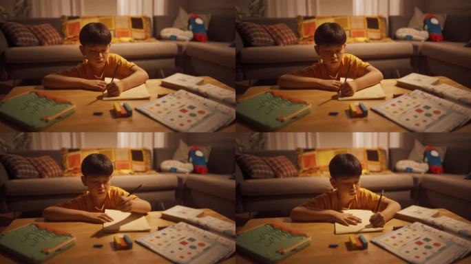 一个可爱的韩国小男孩晚上在家做作业的照片。专注的聪明男孩准备考试，努力学习，解决数学问题