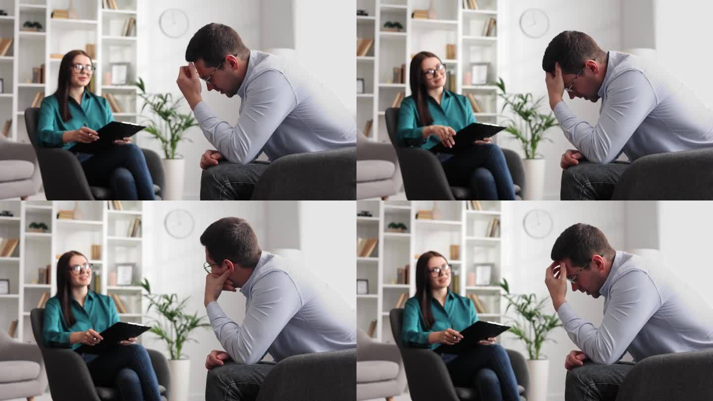一位专业的心理学家正在咨询一位坐在办公室椅子上的压力和抑郁状态的男性病人。她写在纸上。咨询心理学家的