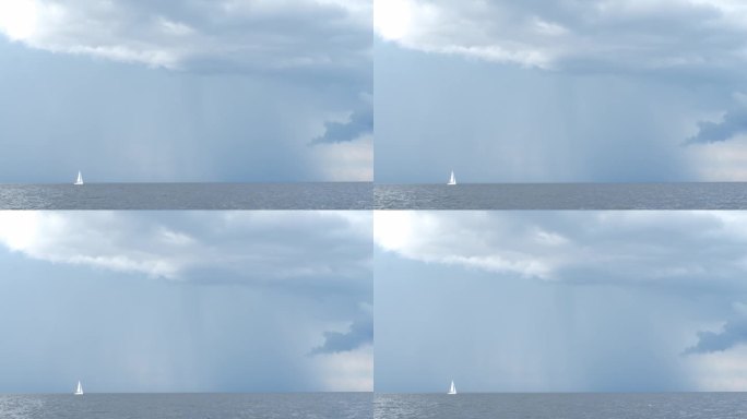 天边下着雨，灰色的雨云和白色的帆船驶向大海，刮风的天气，雷雨，暴风雨。