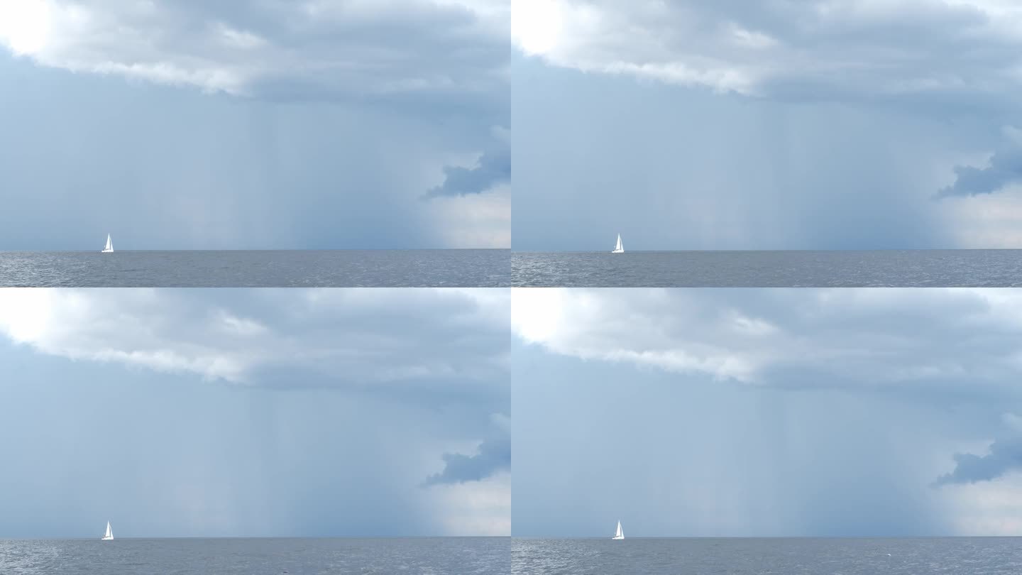 天边下着雨，灰色的雨云和白色的帆船驶向大海，刮风的天气，雷雨，暴风雨。