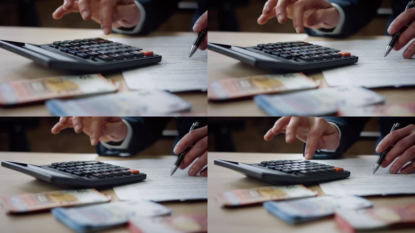 特写男子用计算器计算预算。男性的手在按按钮。