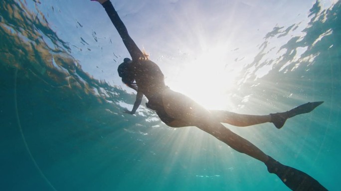 女人保持者。年轻的女自由潜水员在水下游泳，喜欢在水里