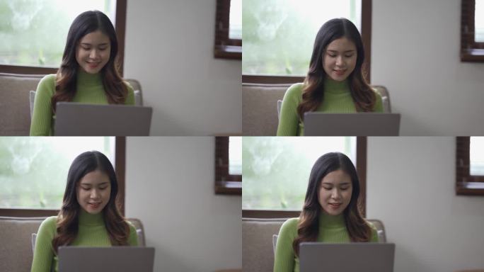 迷人的亚洲女性工作，上网，使用笔记本电脑设备，在家里的客厅地板上工作，表情开朗，快乐。