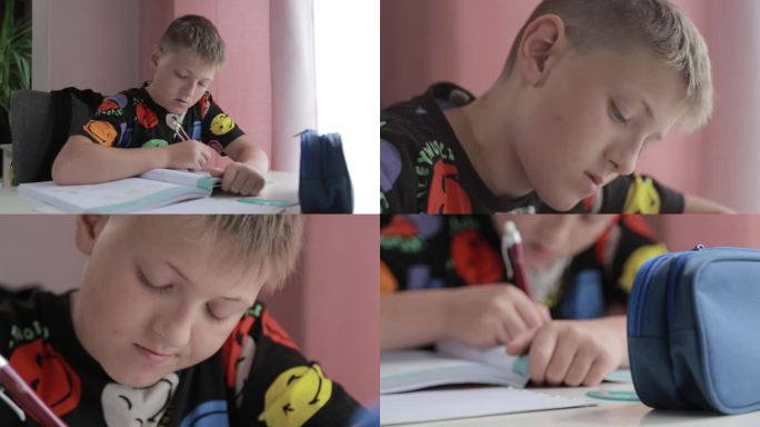 10-11岁的男孩在桌上做作业