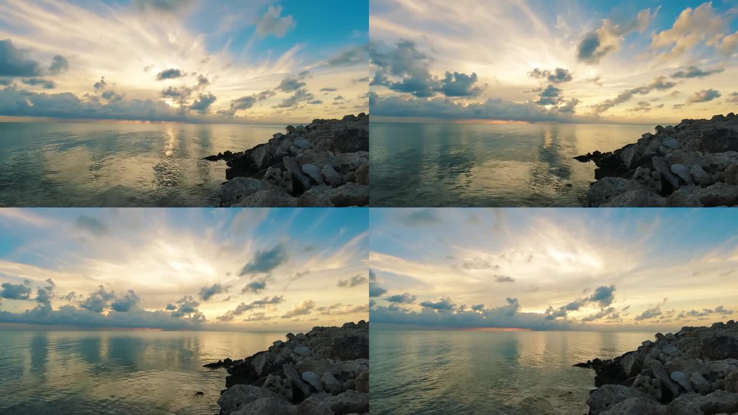 伯利兹的龙涎香礁或海湾附近的海洋上夕阳的延时拍摄。锁定广角镜头