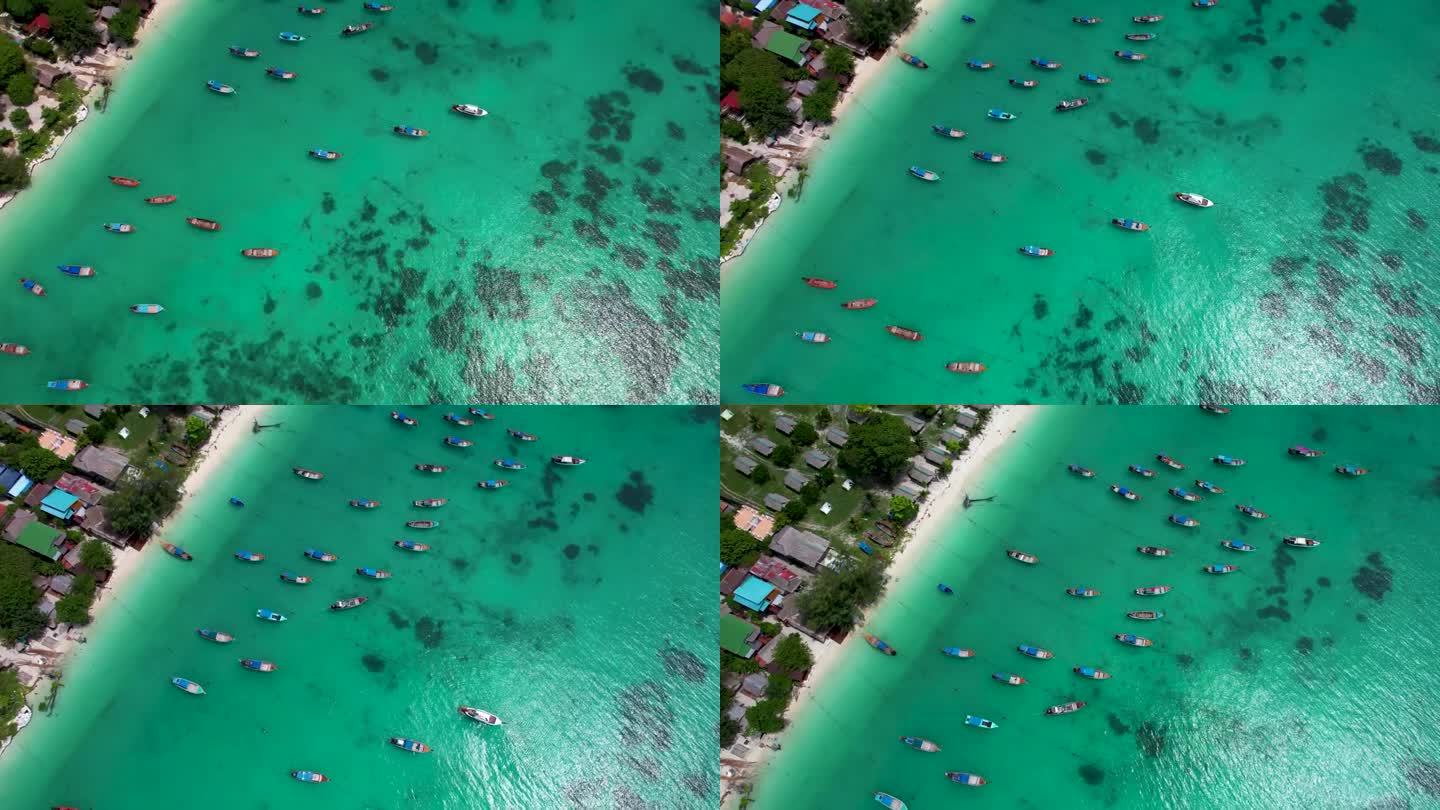泰国岛海岸线上有海滩酒店，长尾船一排排地停泊在空中