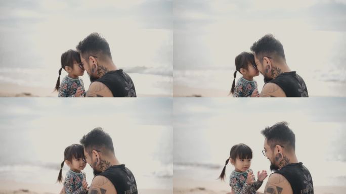 一个亚洲父亲和一个小女孩看着对方的眼睛。父亲和女儿在夏日休闲时面对海景。