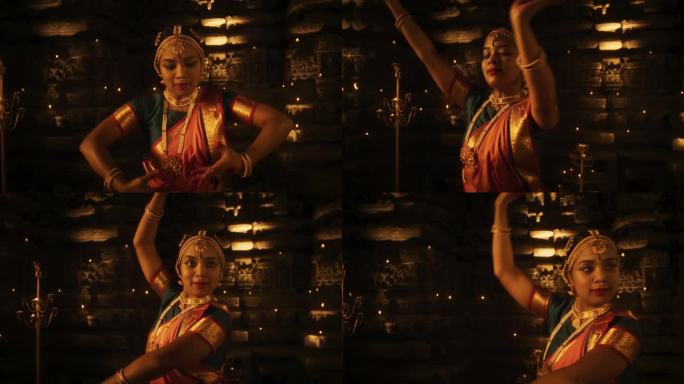一个穿着传统服装的活跃的印度女舞者在一座古老的寺庙里的慢动作肖像。她展示了Bharatanatyam