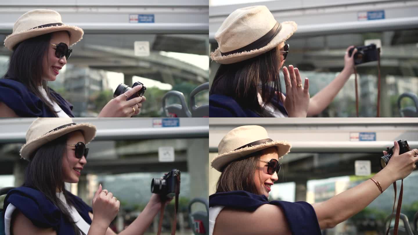 美女在旅游巴士上用相机自拍
