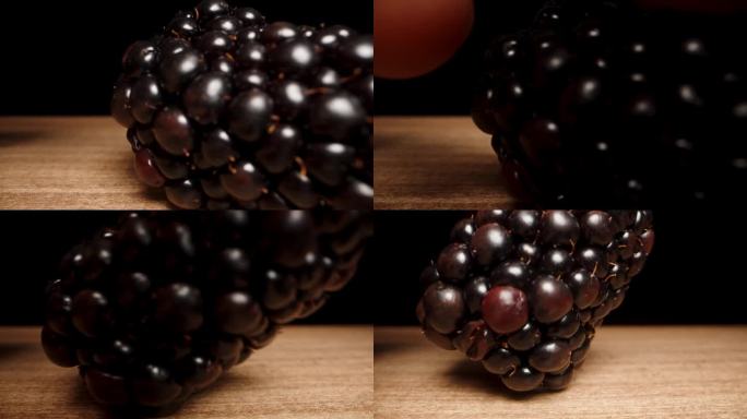 镜头靠近桌子上的黑莓，我拿了一个。多莉滑块极端特写。