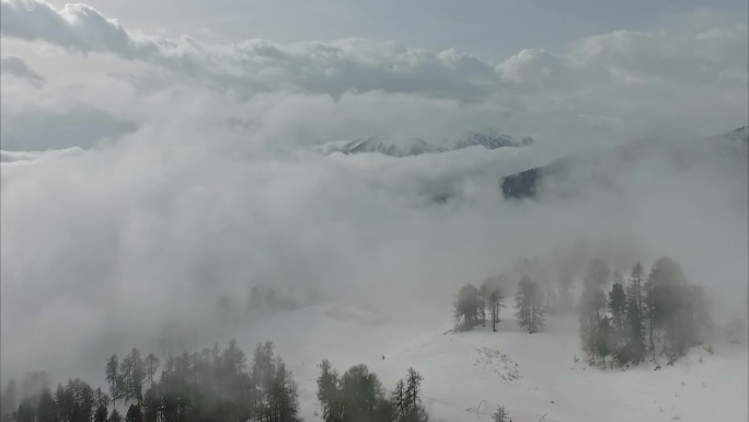 空中拍摄的一个清晰的白色雪景在山上在一个轻微多云的天气在奥地利