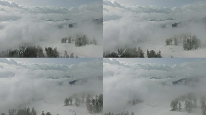 空中拍摄的一个清晰的白色雪景在山上在一个轻微多云的天气在奥地利