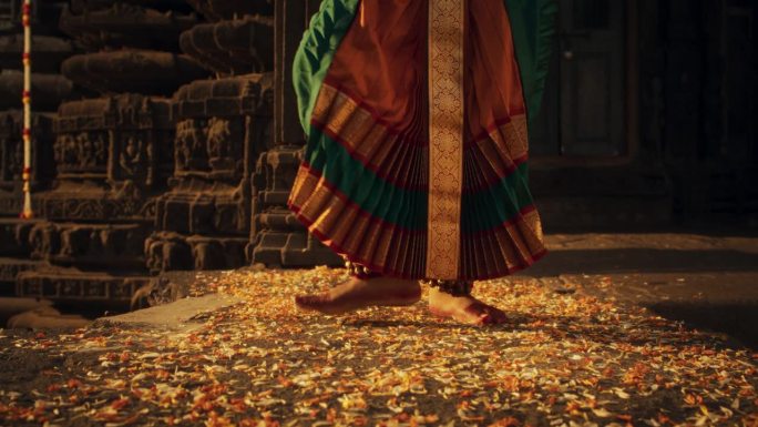 一个印度女舞者的腿做民俗舞蹈的特写镜头。穿着传统纱丽的女孩的地面镜头迅速展示了巴拉塔纳塔姆舞蹈的艺术