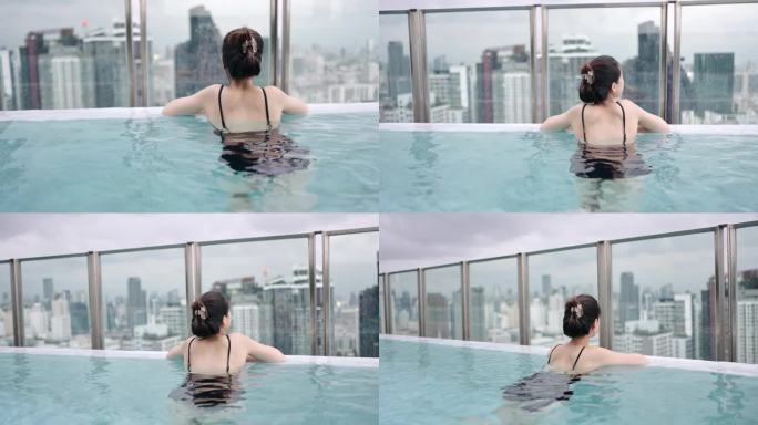 积极健康的生活方式，高净值的亚洲女性享受她的一天在豪华游泳池