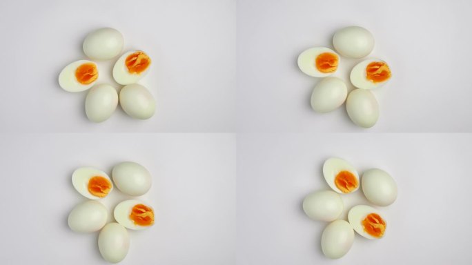 在蛋清上旋转半切的煮鸡蛋。