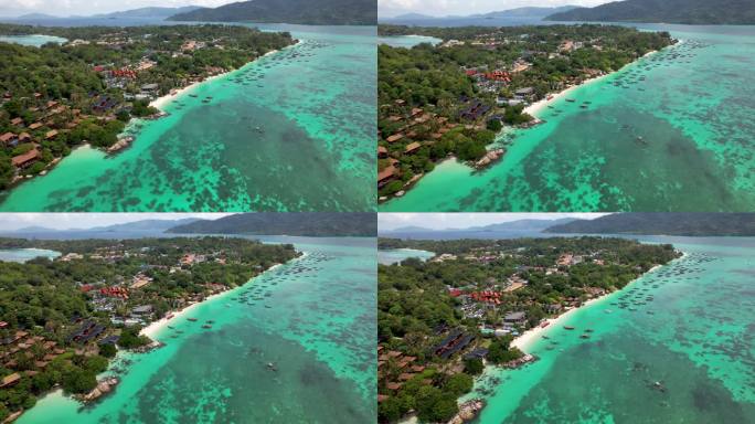 泰国里佩岛的海岸线上停靠着船只，绿松石般的海水上有珊瑚礁