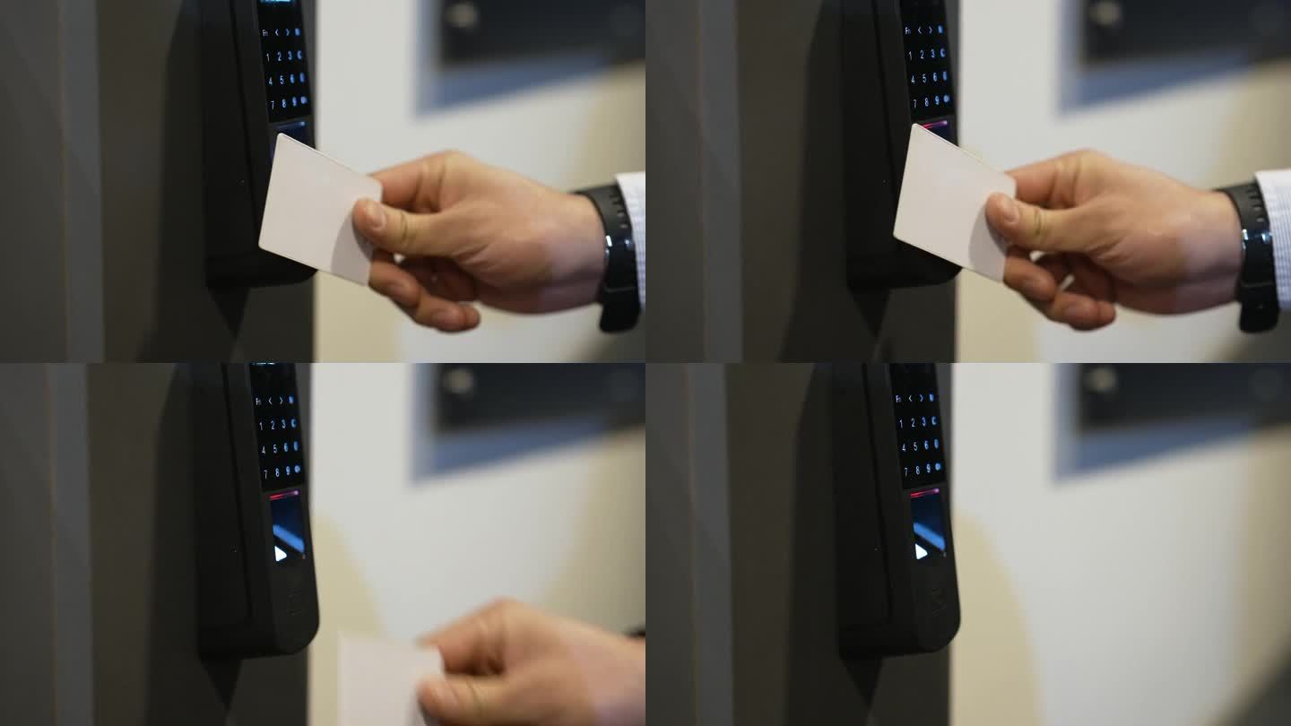 在卡片扫描器前挥动安全徽章的人的手的特写镜头