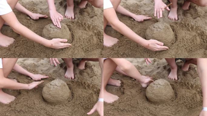 孩子们在沙滩上用手玩耍，堆沙堡