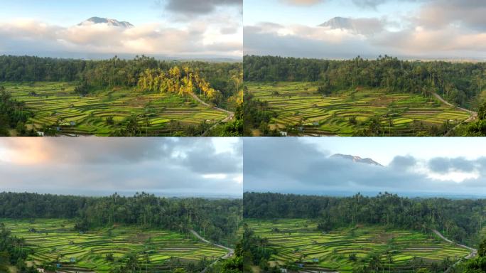 印尼巴厘岛，阿贡火山的延时移动云日落场景，前景是稻田梯田。
