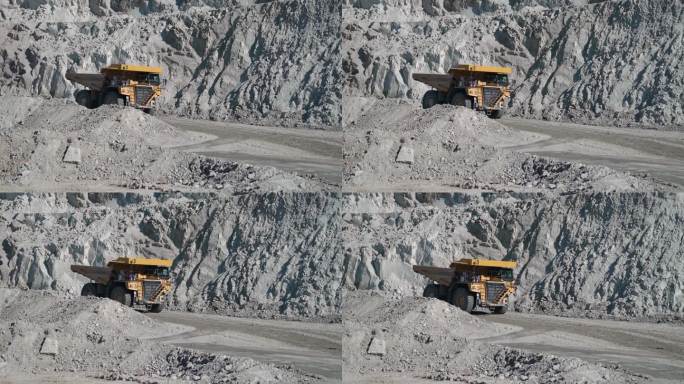 大型采石场自卸车在露天矿山运输矿石，慢动作