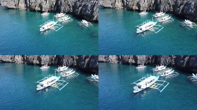传统的支腿跳岛游船停泊在菲律宾爱妮岛的秘密海滩上。空中摄影车