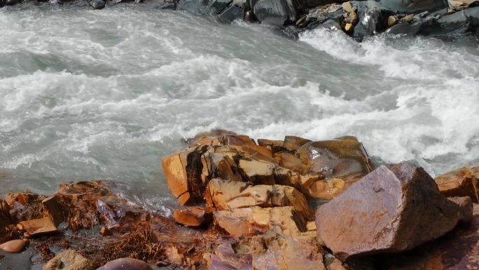 狂风暴雨、清澈冰冷的特雷克河流入乔治亚州卡兹贝吉地区的特鲁索山谷峡谷。北高加索的性质。橙色的石头上涂