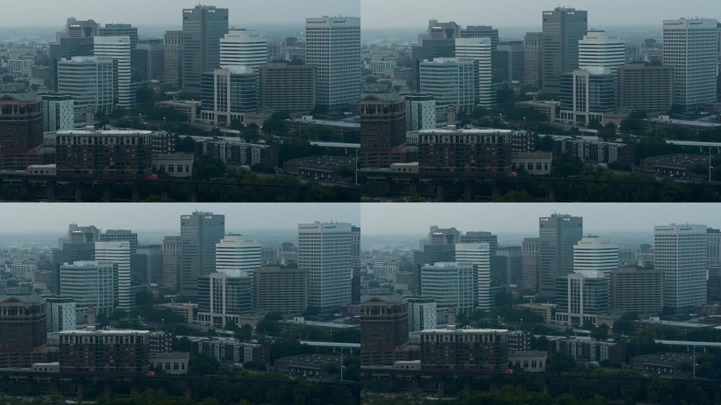 里士满摩天大楼中的烟雾。黄昏的城市景观里士满市中心，弗吉尼亚州。航拍镜头与相机向后移动