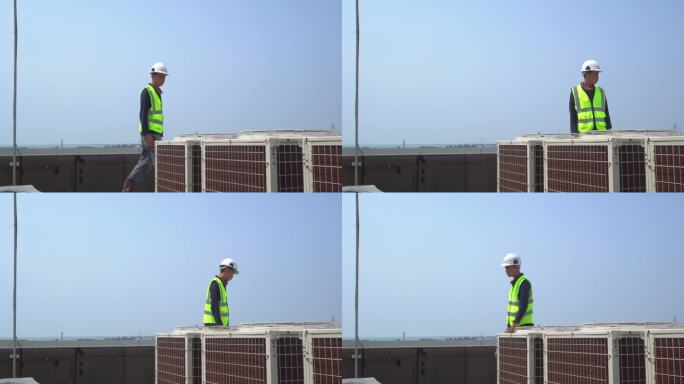 工技人员对工业楼顶室外风机空调进行检查