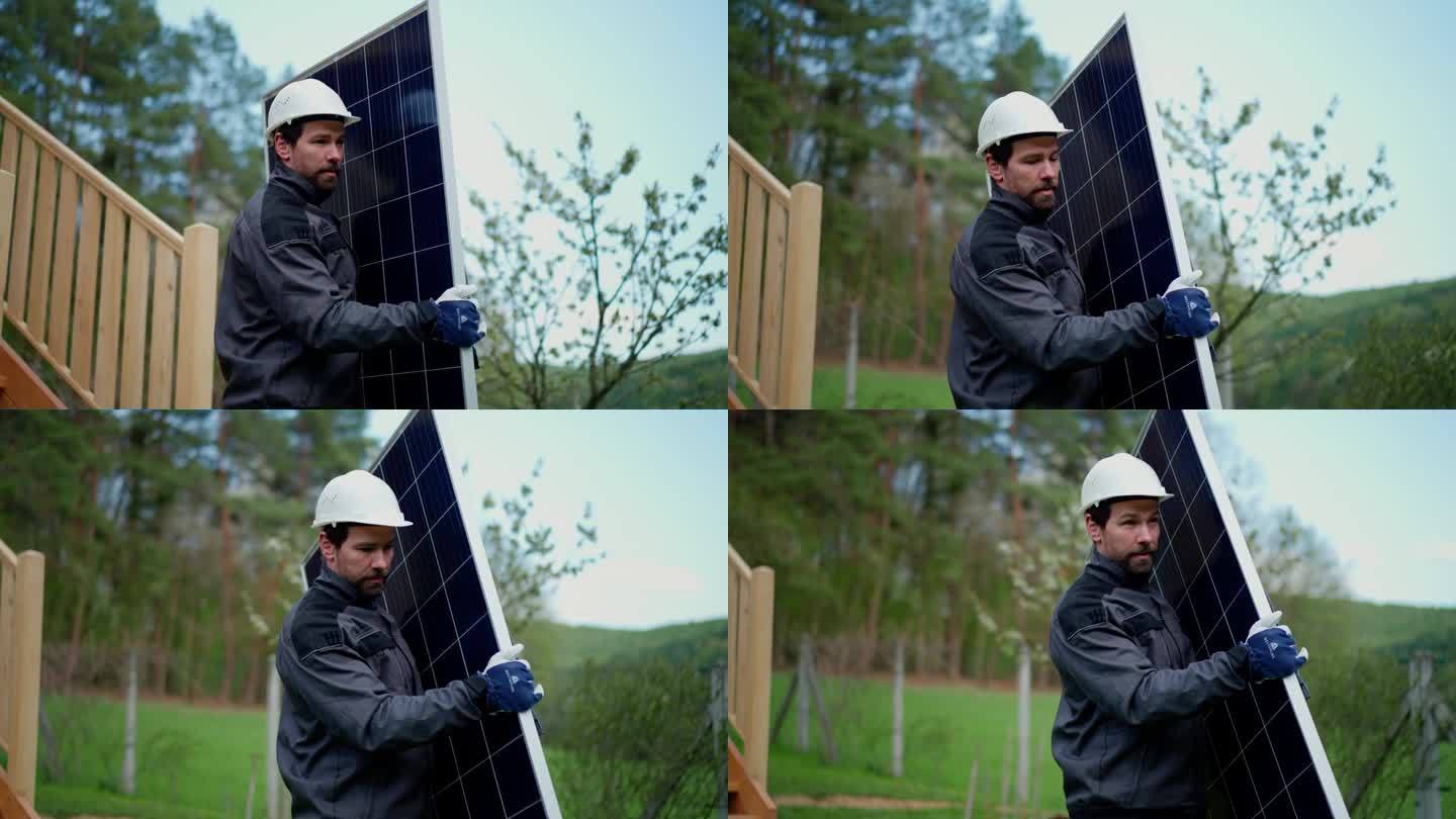 一名工人正在搬运太阳能板，以便在房屋上安装太阳能模块系统。