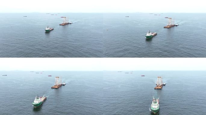 拖船拖着船上的大型建筑。驳船运输平台上的招标钻井平台到海洋中央的石油钻井平台