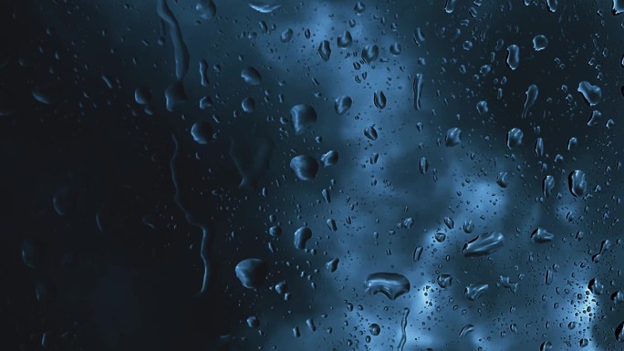 雨滴在窗口深蓝色抽象背景