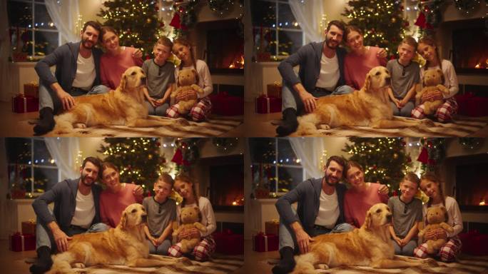 一个快乐的年轻家庭在镜头前摆姿势，微笑着互相拥抱的圣诞肖像。丈夫、妻子、女儿、儿子和一只宠物金毛猎犬