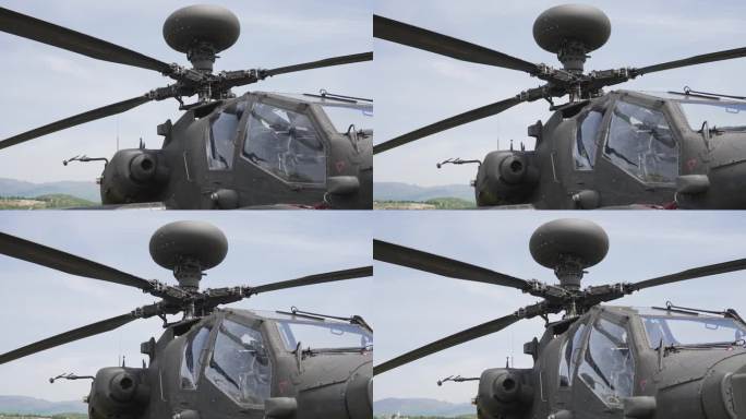 阿帕奇军用直升机螺旋桨特写，背景是蓝天