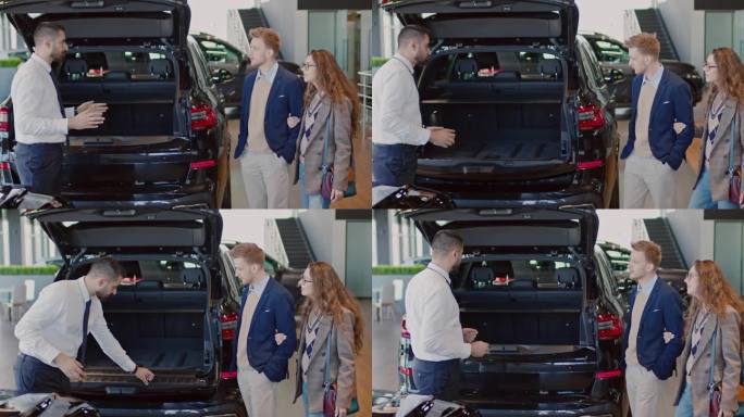 销售经理向年轻夫妇展示新款跨界车后备箱