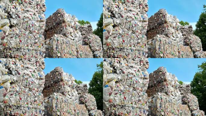 多堆压缩透明塑料垃圾在露天废物回收厂。慢动作