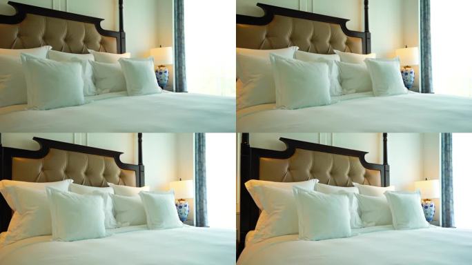 舒适宽敞的豪华酒店特大号床旁边的一个窗口，平移拍摄
